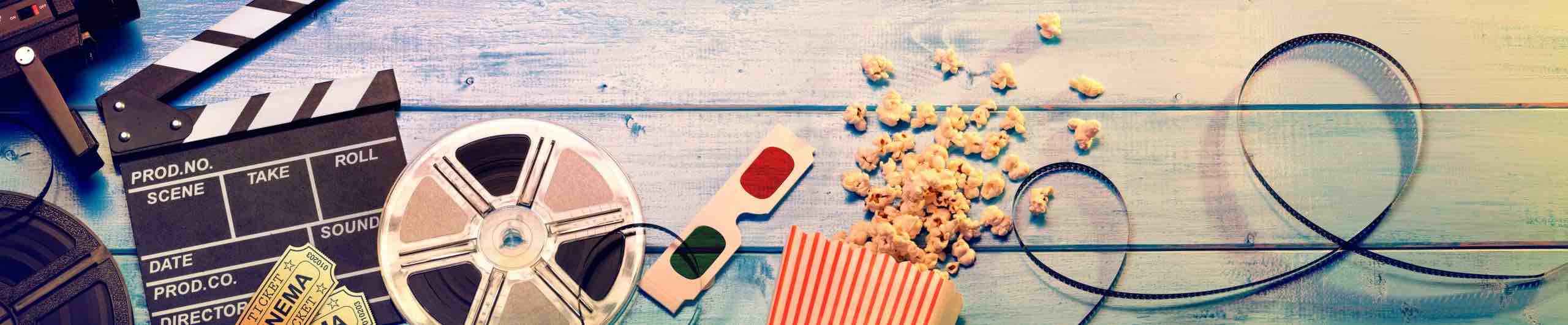 Movie reel, popcorn and movie items spread on the floor